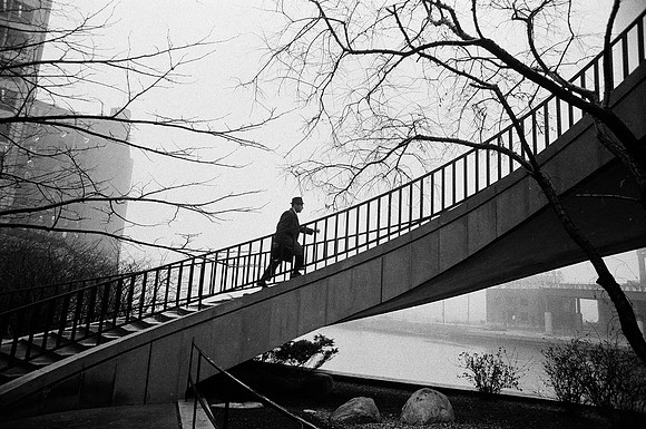 Pedestrian walking up a set of stairs near the Chicago River (ST-20001421-0007)
