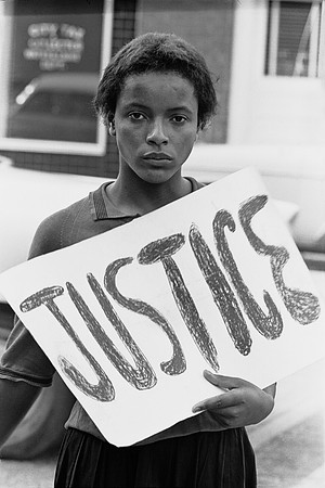 Female protester carrying Justice sign