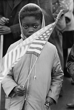 Little girl holding American flag at parade